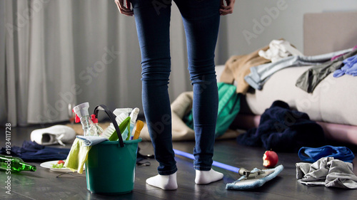 Obraz na płótnie Woman horrified by mess left after party in her apartment, cleaning service