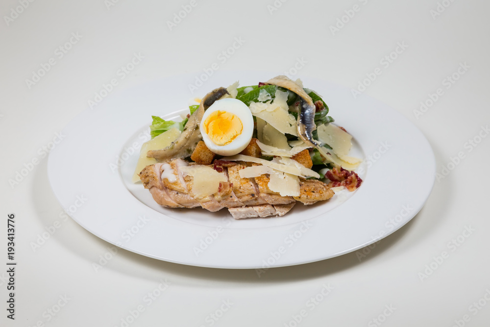 Chicken Salad with egg and cheese  on a white plate on a white background isolated