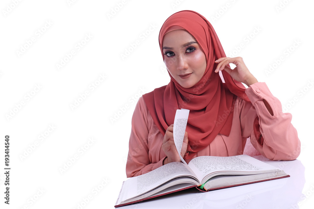 portrait of Muslim Asian girl reading Arabic book with facial emotional reactions portrait of Muslim Asian girl reading Arabic book with facial emotional reactions