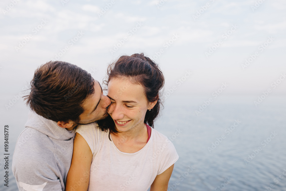 Young couple kissing near the sea. soft focus on eyes Young couple kissing near the sea. soft focus on eyes