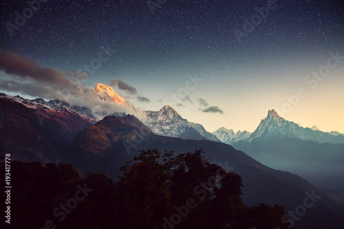 Night landscape on early morning. Starry sky with over the mountains.