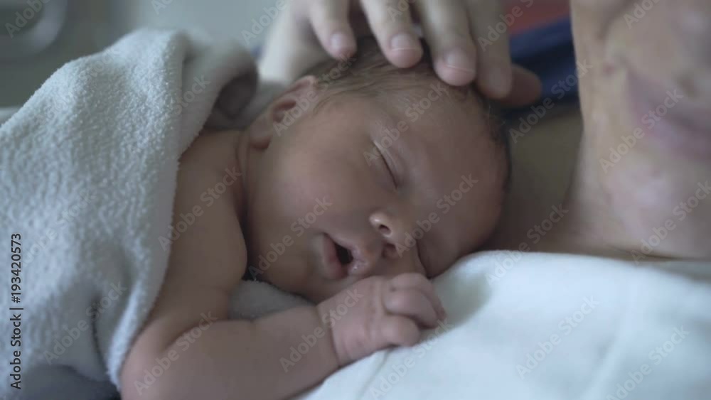 Newborn looks cute while sleeping on his mother
Newborn looks cute while sleeping on his mother
