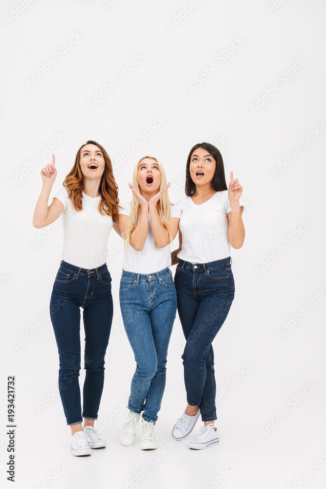 Full length portrait of three surprised casual girls Full length portrait of three surprised casual girls
