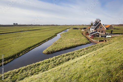 Fototapeta Dutch polder landscape with a farm and some houses
