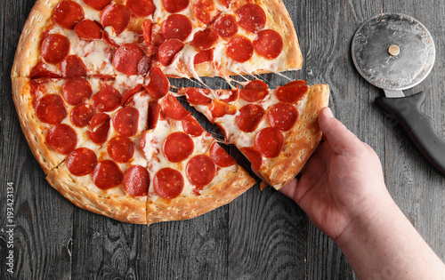 Hand pulls pizza