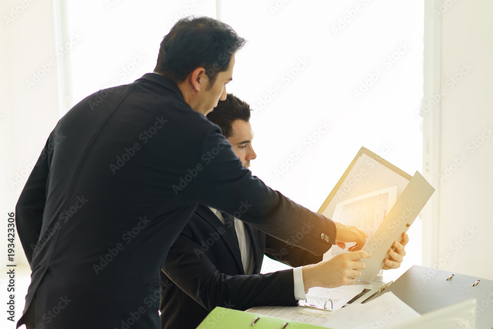 They are meeting new project so serius.Businessman looking at taplet and information in office.Businessman working at office with documents file on his desk.Meeting start up project