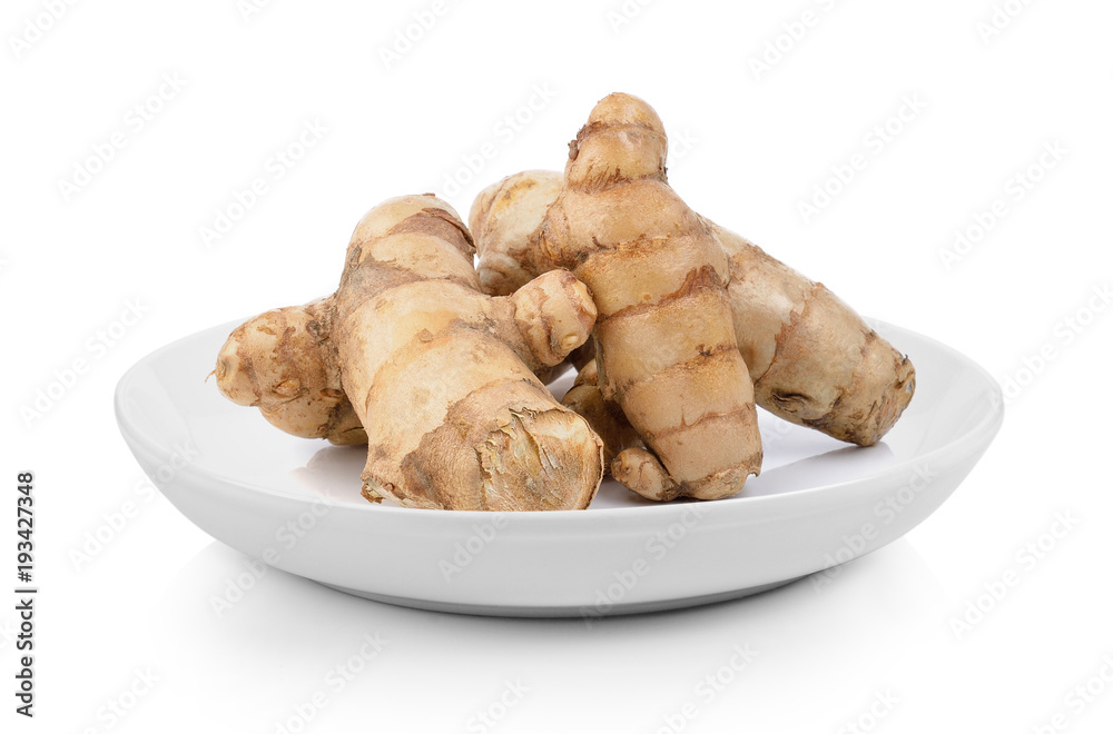 fresh turmeric  in plate on white background