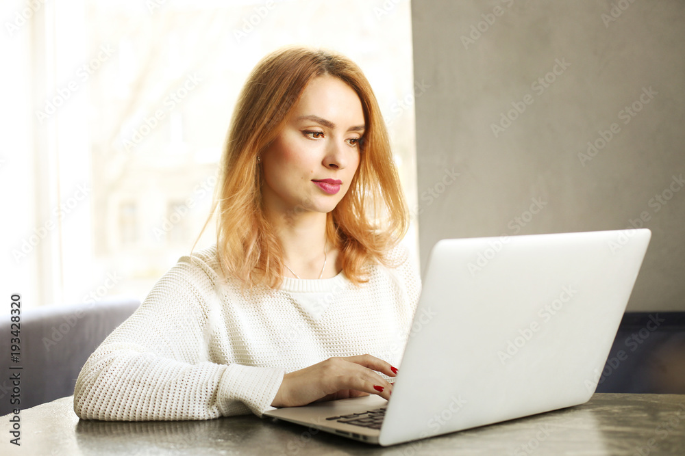 Attractive hipster young woman in modern loft cafe coffee shop restaurant. Writer, blogger, designer, freelancer, remote work process. E-shopping, online shopping, m-shopping. Attractive hipster young woman in modern loft cafe coffee shop restaurant. Writer, blogger, designer, freelancer, remote work process. E-shopping, online shopping, m-shopping.