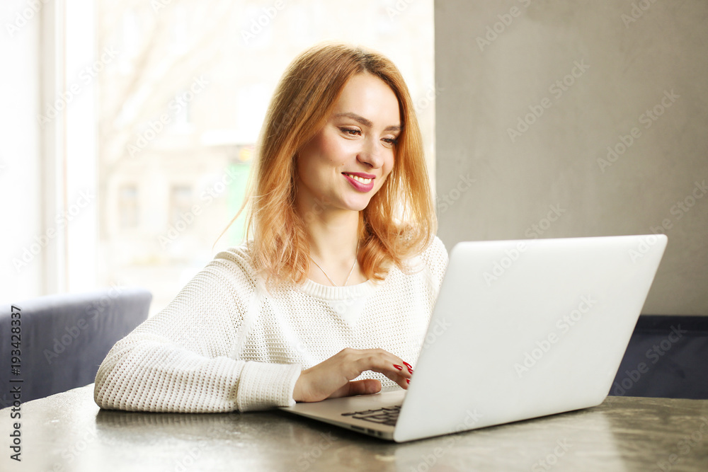 Attractive hipster young woman in modern loft cafe coffee shop restaurant. Writer, blogger, designer, freelancer, remote work process. E-shopping, online shopping, m-shopping. Attractive hipster young woman in modern loft cafe coffee shop restaurant. Writer, blogger, designer, freelancer, remote work process. E-shopping, online shopping, m-shopping.