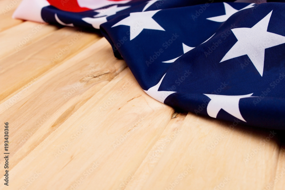 Fototapeta premium The Flag Of The United States Of America. American flag on a light wooden background. The view from the top.Happy holiday USA.