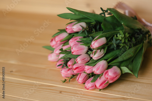 Pink tulips on a wooden background