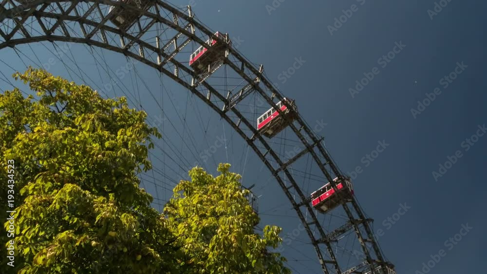 Hyper time lapse movement of giant Riesenrad ferris wheel on clear blue sky background in the Prater park Austria Vienna tourist attraction Europe travel Hyper time lapse movement of giant Riesenrad ferris wheel on clear blue sky background in the Prater park Austria Vienna tourist attraction Europe travel