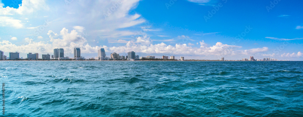 Fort Lauderdale, near Miami, Florida, USA. 
Landscape of beach skyline and coastal luxurious buildings against blue sky a summer sunny day. Panoramic view from the ocean surface.