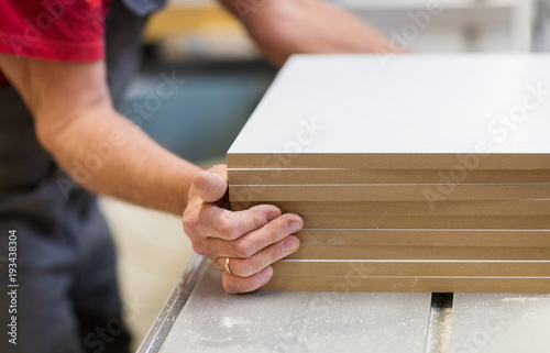 фотографія close up of carpenter with boards at factory