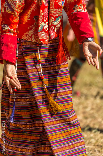 Female dancer in traditional bhutanese clothes photo