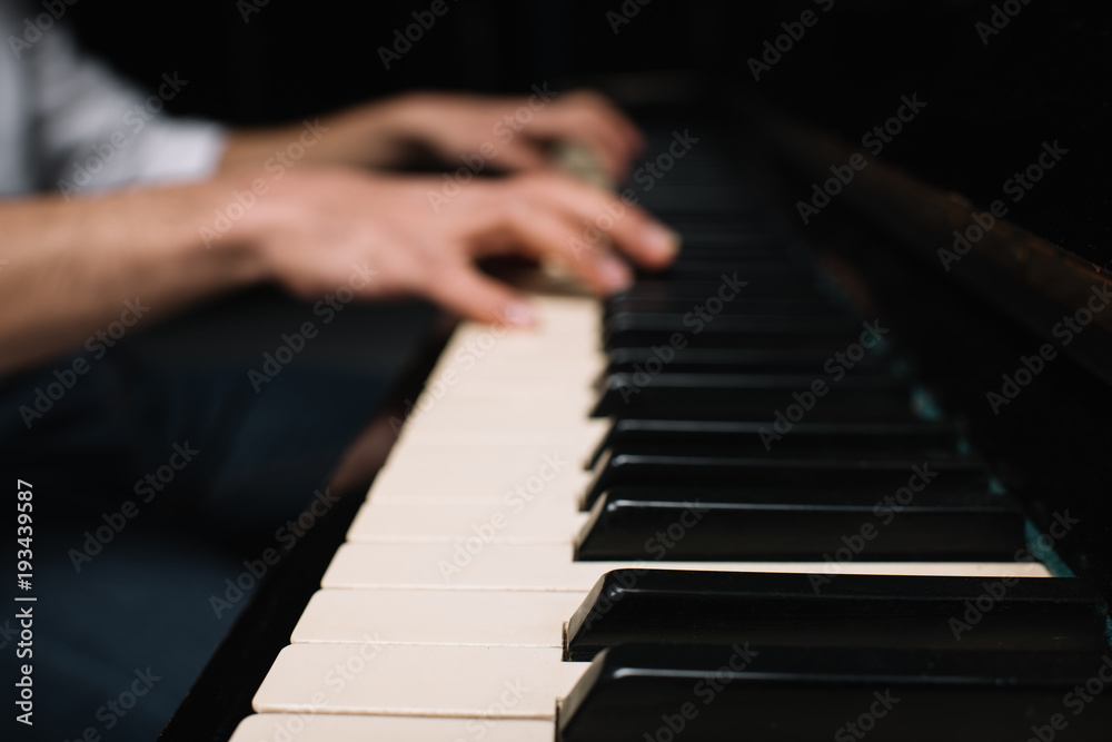 Fototapeta premium cropped shot of musician playing piano