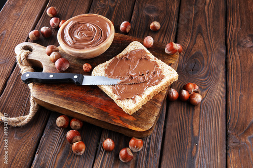 Obraz na plátně Homemade hazelnut spread with toast and in wooden bowl for breakfast