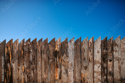Old wooden fence and clear sky.