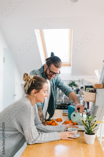 Young couple making breakfast and having fun 