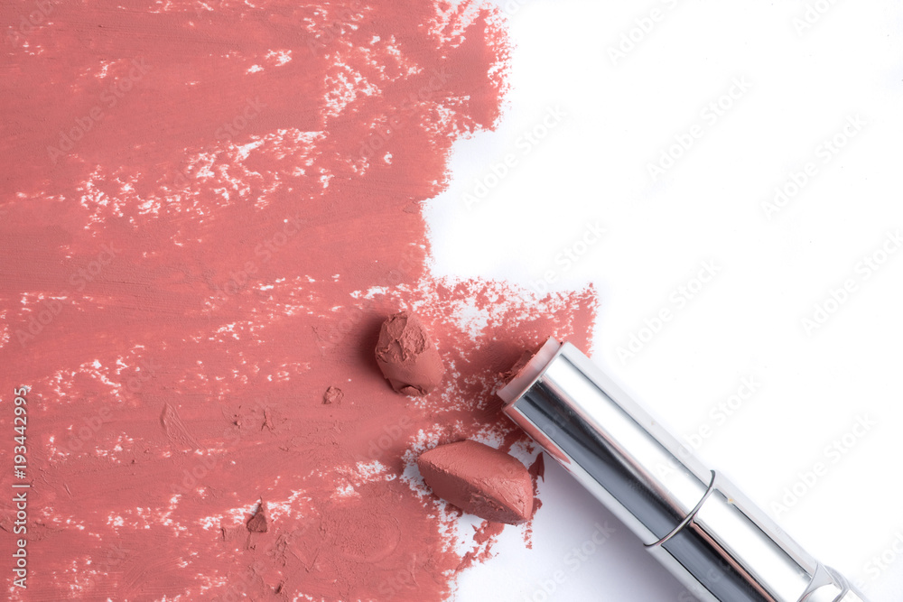 Fototapeta premium Smudged pink lipstick on white background.