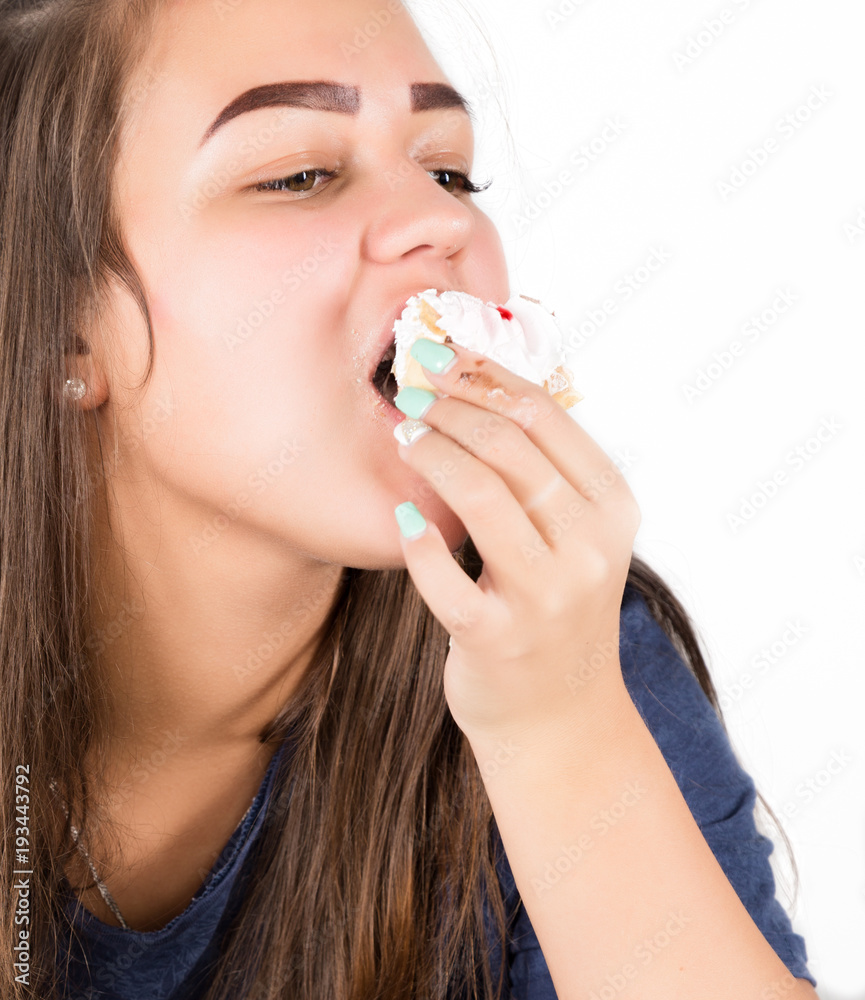 Young woman eating cupcakes with pleasure after a diet Young woman eating cupcakes with pleasure after a diet