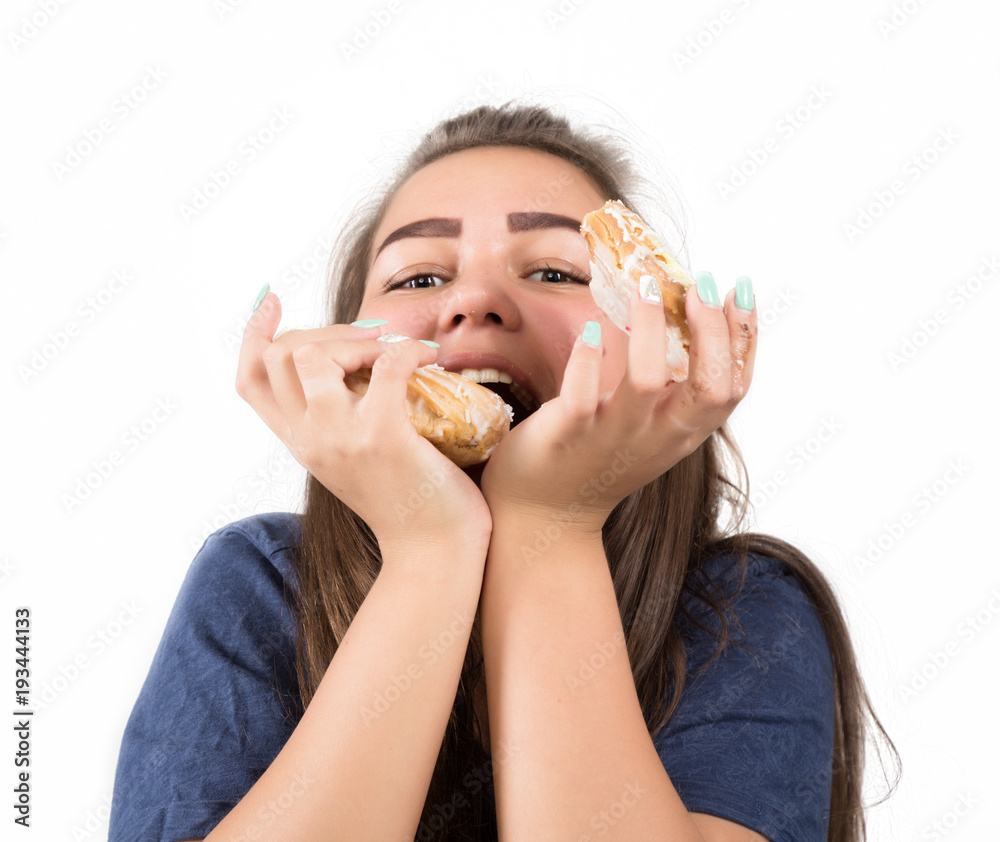 Young woman eating cupcakes with pleasure after a diet Young woman eating cupcakes with pleasure after a diet