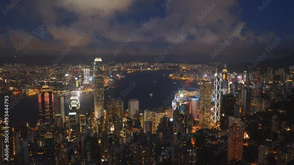 night panning shot of victoria harbour and hong kong island from the peak in hong kong, china night panning shot of victoria harbour and hong kong island from the peak in hong kong, china