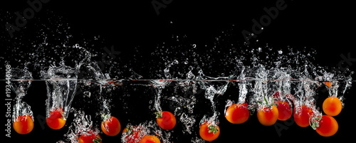group of tomatoes in water splash
