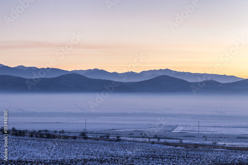 City covered by the fog during sunset