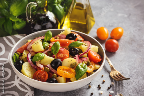 Potato salad with tomatoes, olives, capers, red onion, italian style cuisine. Insalata Pantesca.