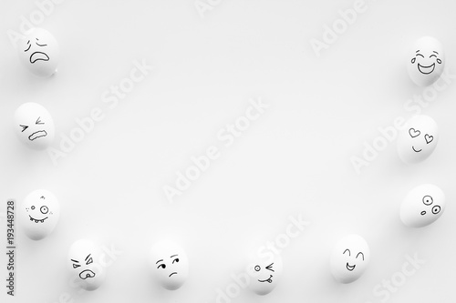 Basic emotions concept. Faces drawn on eggs. Happy, smile, sad, angry, in love. White background top view copy space