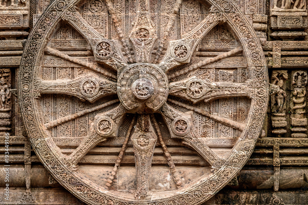 Intricate carvings on a stone wheel in the ancient  Hindu Sun Temple at Konark, Orissa, India.