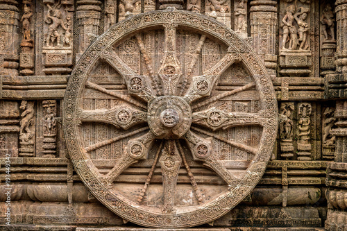 Intricate carvings on a stone wheel in the ancient Hindu Sun Temple at Konark, Orissa, India.