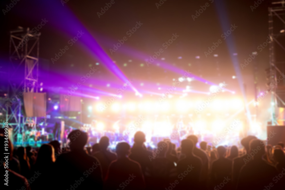 Blurred background : Bokeh lighting in outdoor concert with cheering audience