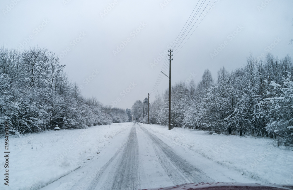 Snowy road with wintry road conditions View from a moving car Snowy road with wintry road conditions View from a moving car
