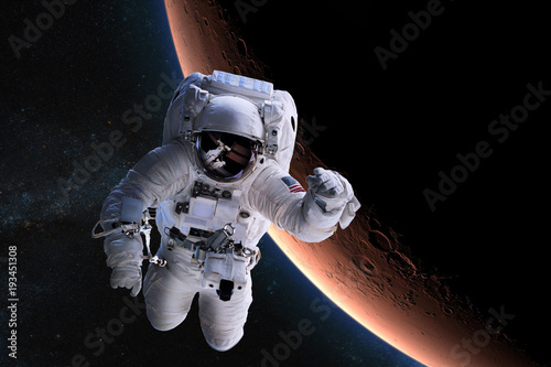 Fototapeta Naklejka Na Ścianę i Meble -  Astronaut in outer space on background of the Mars. Elements of this image furnished by NASA.