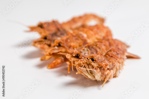 shrimp langoustine lie on a white background