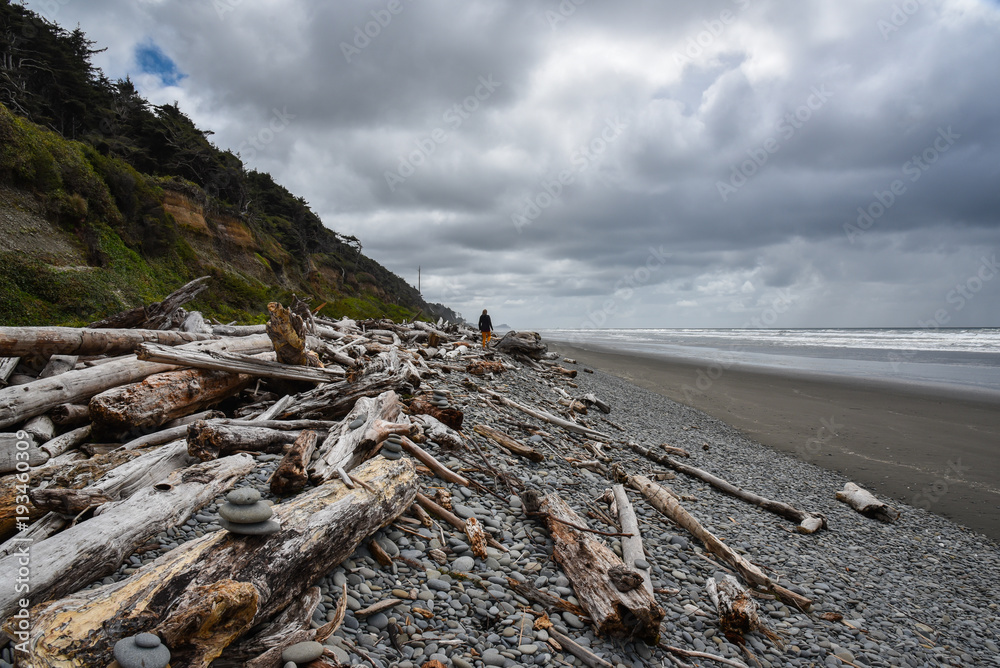 Woman stands on rugged beach on Washington's Olympic Coast Woman stands on rugged beach on Washington's Olympic Coast