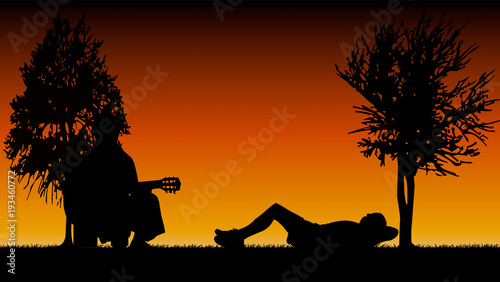 détente allongé dans un parc avec guitariste le soir