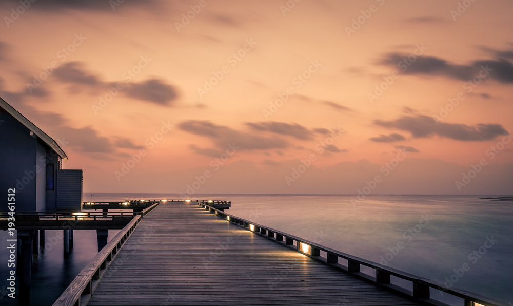 Fototapeta premium Wooden jetty and amazing sunrise in Maldives