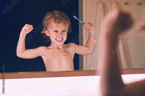 Little boy brushing teeth photo