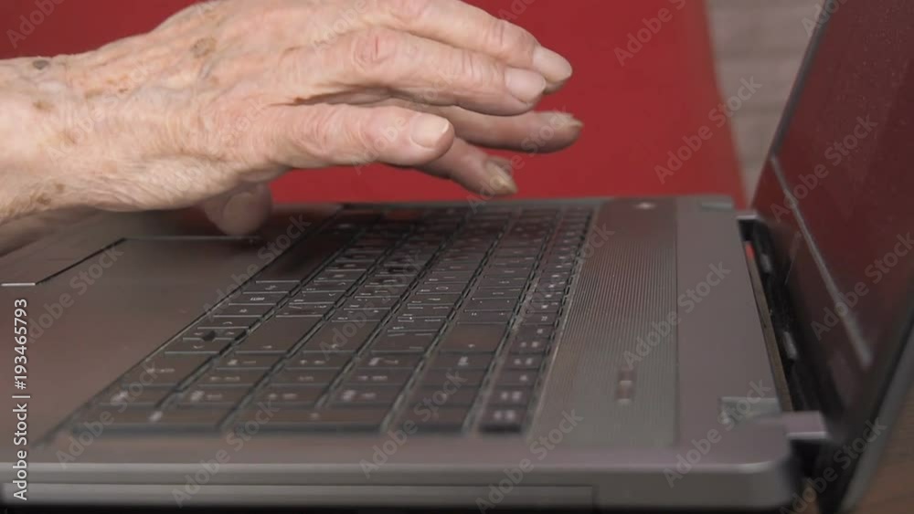 Hands of an old man working on the keyboard. Hands of the old woman on the keyboard. Hands of an old man working on the keyboard. Hands of the old woman on the keyboard.