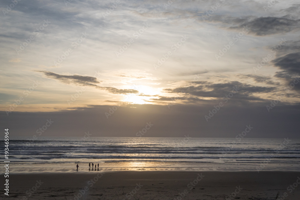 Family on the beach at sunset