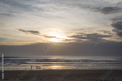 Family on the beach at sunset