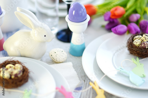 Beautiful table setting with crockery and flowers for Easter celebration