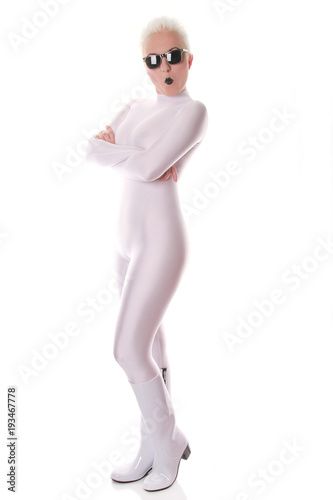 strange fashionable woman wearing white spandex fetish tight catsuit and black sunglasses posing on white background isolated photo