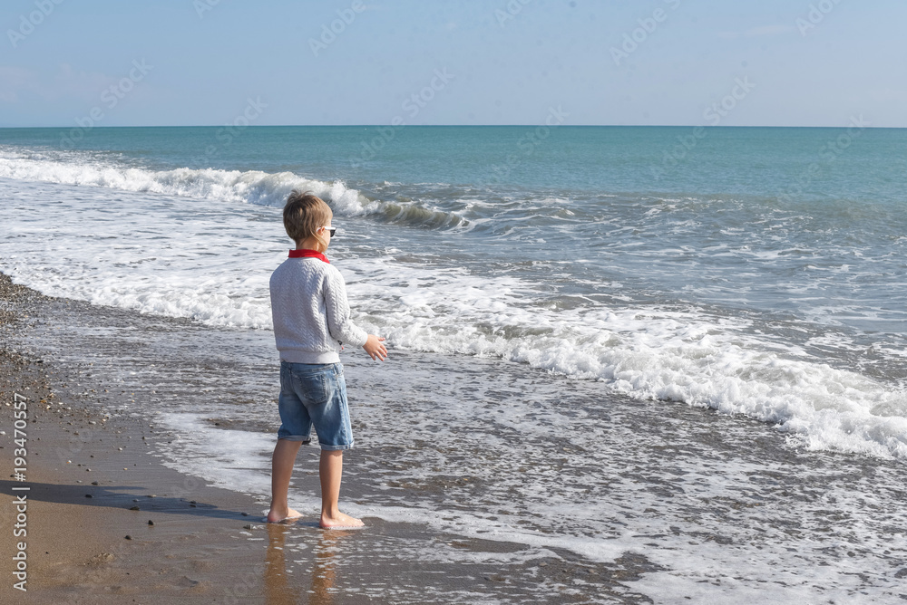 little boy near cold sea