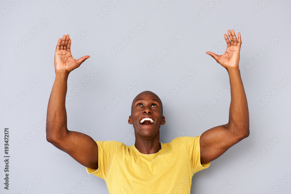happy black man with arms and hands raised to lift - obrazy, fototapety, plakaty 