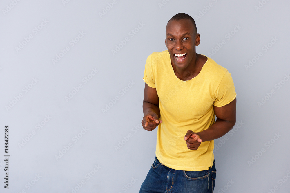 cheerful young black man smiling and pointing fingers cheerful young black man smiling and pointing fingers