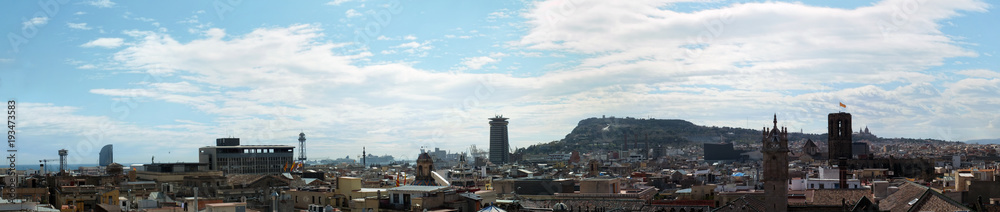 wide panoramic aerial cityscape view of barcelona showing the historic buildings towers and churches skyline with coast sea and docks and montjuic area wide panoramic aerial cityscape view of barcelona showing the historic buildings towers and churches skyline with coast sea and docks and montjuic area